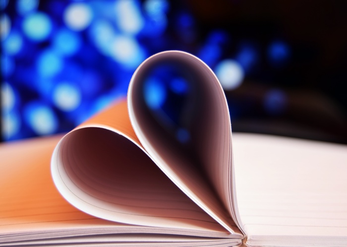 Open notebook pages shaped into a heart