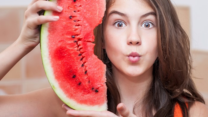 Girl holding a slice of watermelon