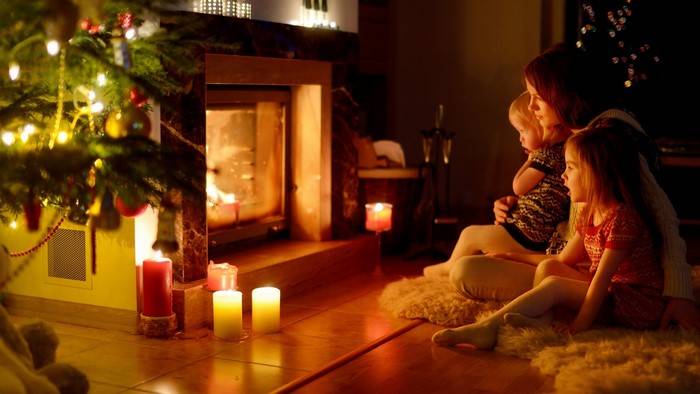 Family by the fireplace on Christmas