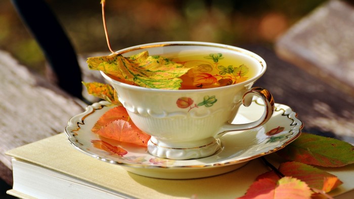 Tea with autumn leaves in a teacup