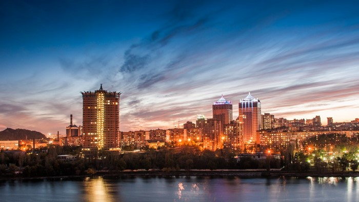 Donetsk skyline at dusk with river