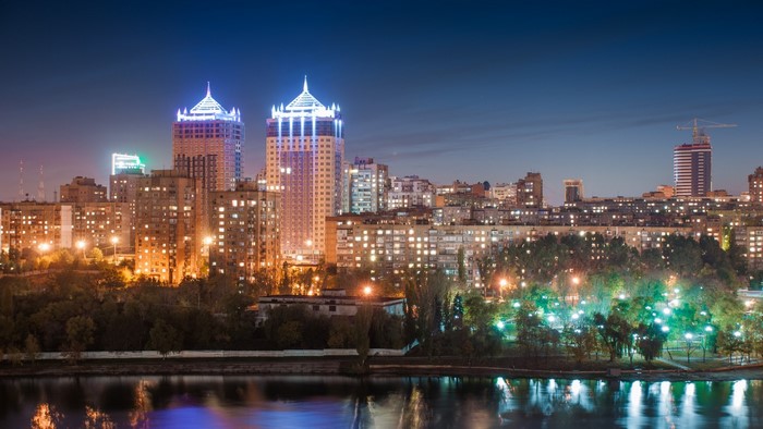 Donetsk skyline at night with river reflection