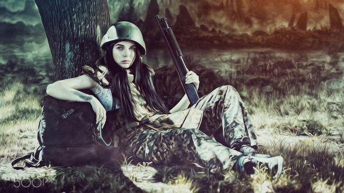 Woman in camouflage with shotgun and helmet