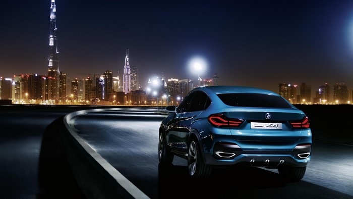 BMW X4 on a road in Dubai at night