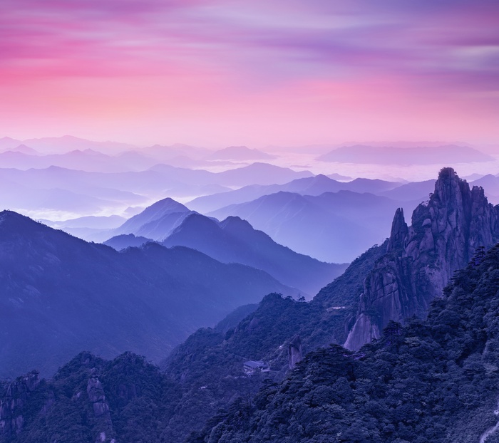 Misty mountains at sunrise with pink sky