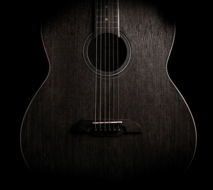 Acoustic guitar on a black background