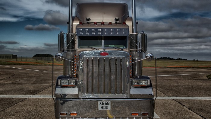 Peterbilt truck on asphalt with cloudy sky