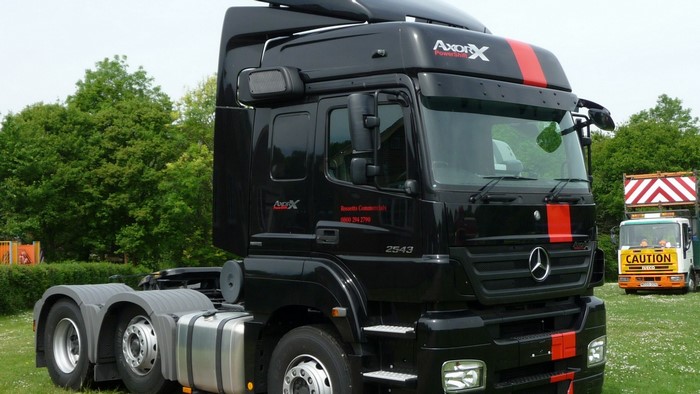 Black Mercedes Benz Axor tractor unit with red stripes