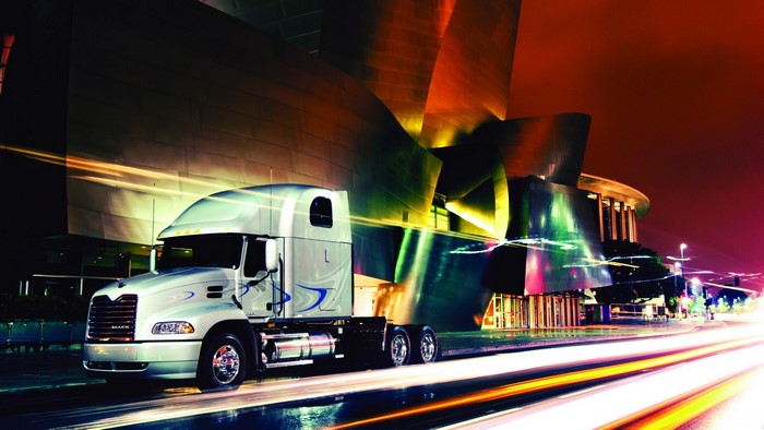 Mack Trucks on a City Street at Night