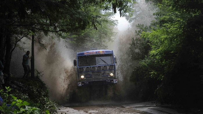 KAMAZ truck driving through water with Red Bull logos