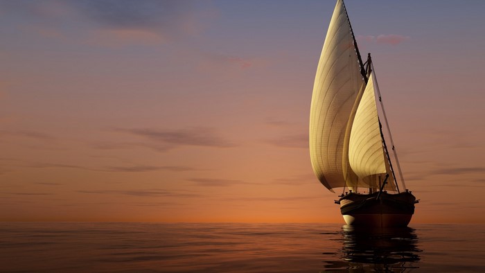 Sailboat on the ocean at sunset