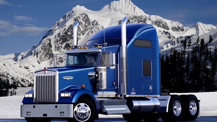 Blue Kenworth Truck in Snowy Mountains