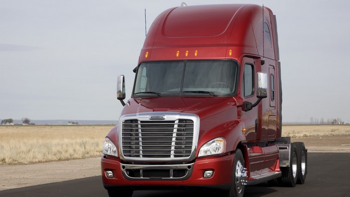 Red Freightliner Cascadia Semi-Truck on Road