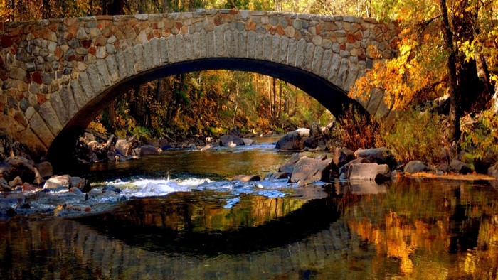 Stone bridge over a river in autumn