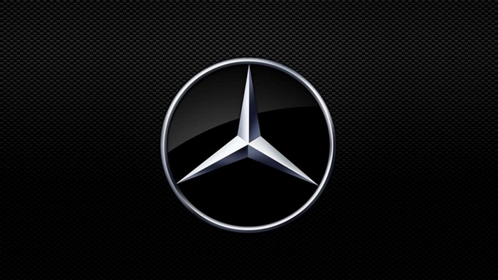 Mercedes Benz logo on black carbon fiber