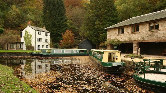 Narrowboats on a canal in autumn