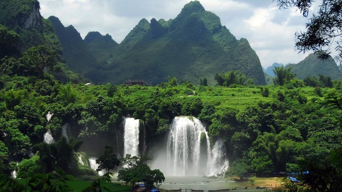 Beautiful waterfalls cascading down green mountains