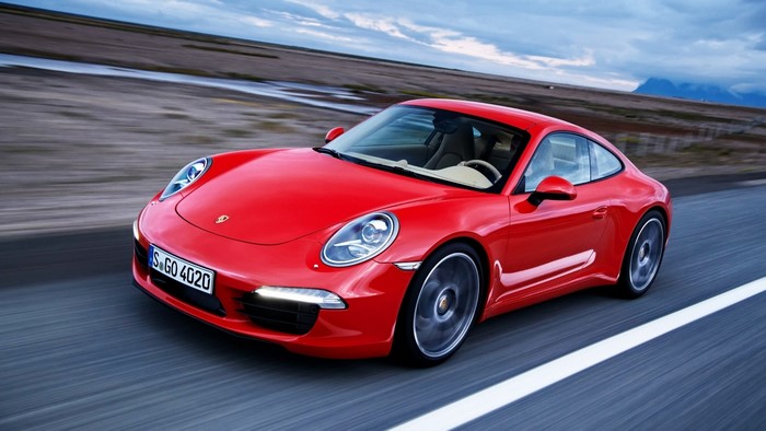 Red 2012 Porsche 911 Carrera driving on road
