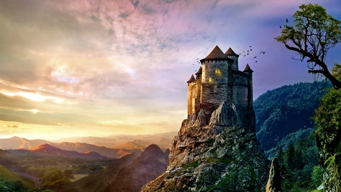 Castle on a rocky mountain at sunset