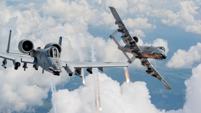 Two A-10 Thunderbolt II aircraft firing flares