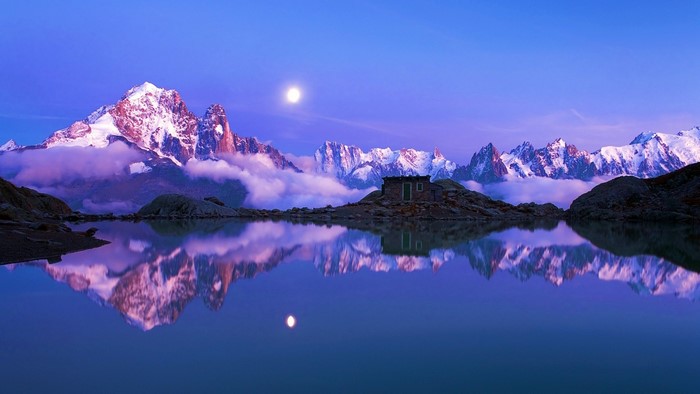 Moonlit Mountains Reflected in a Lake with a Cabin
