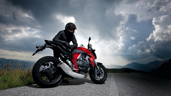Man in Leather Jacket on Red Honda Motorcycle