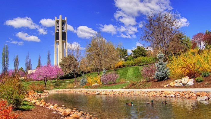 Spring park with pond and bell tower