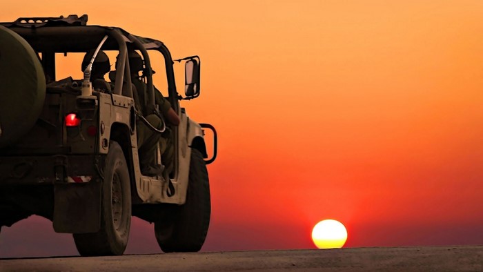 Military Jeep at Desert Sunset