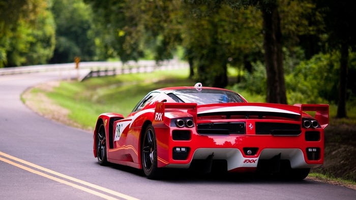 Red Ferrari FXX on a Winding Road