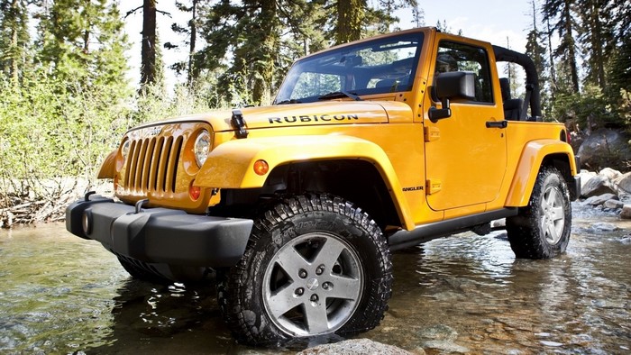 Yellow 2012 Jeep Wrangler Rubicon in stream