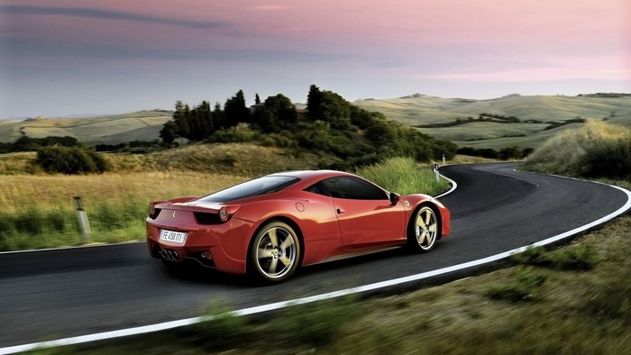 Red Ferrari 458 Spider on a Winding Road