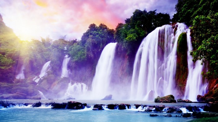 Fantasy Waterfall with Sunbeams and Colorful Sky