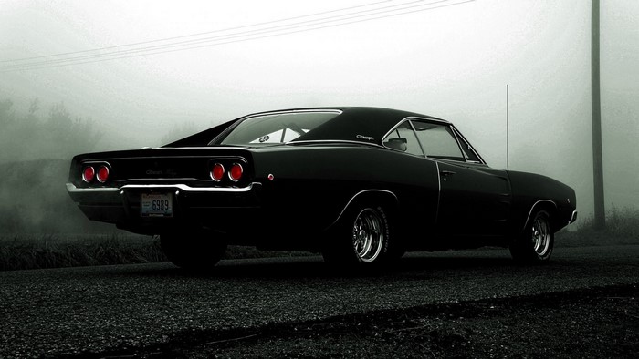 Classic Black Dodge Charger on a foggy road