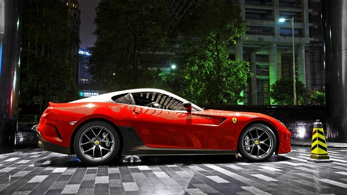 Red Ferrari parked at night