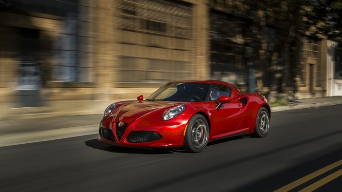 Red Alfa Romeo 4C driving on a street