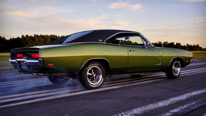 Classic green Dodge Charger doing a burnout