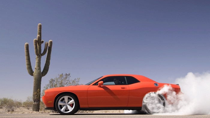 Orange Dodge Challenger SRT8 doing a burnout
