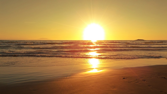 Sunset over the ocean with beach