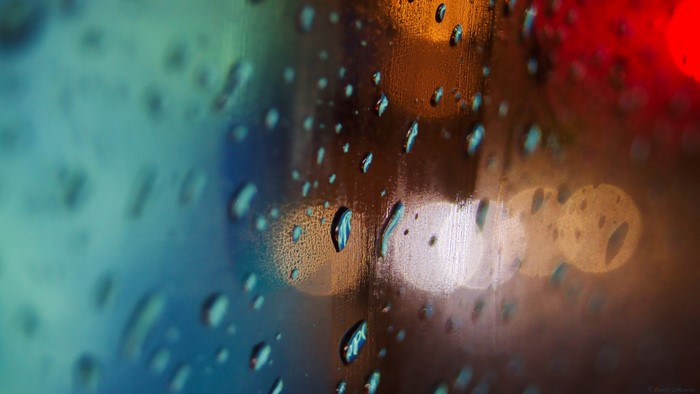 Water droplets on glass with bokeh lights