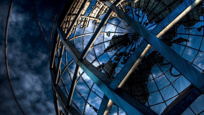 Metal Globe Structure Against Cloudy Sky