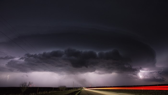 Thunderstorm time lapse with lightning over a road