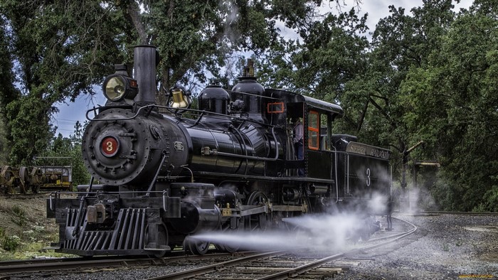 Old black steam locomotive number 3 on tracks