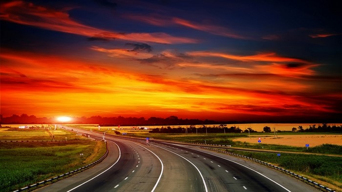 Highway at sunset with dramatic sky