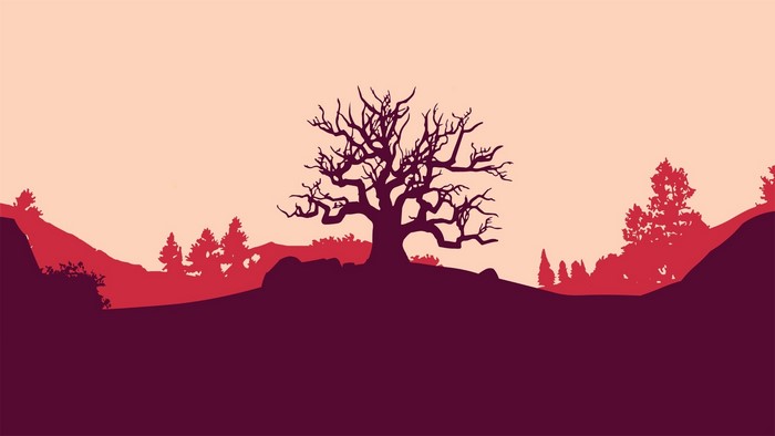 Silhouette of a bare tree on a hill