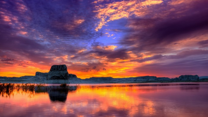 Colorful Sunset Over Lake and Rock Formations