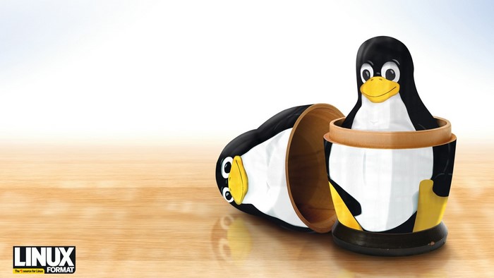 Linux Tux Nesting Dolls on Wooden Surface