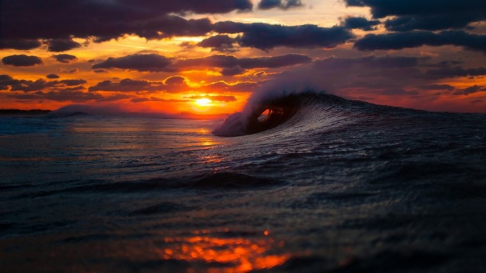 Wave crashing at sunset