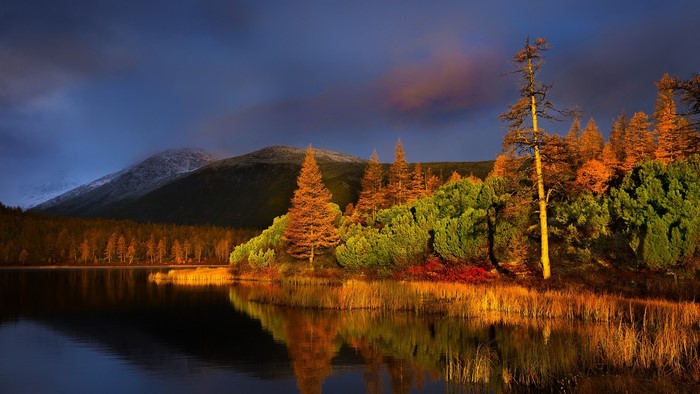 Autumn lake with mountains and trees