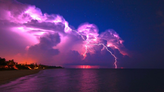 Lightning storm over the ocean at dusk
