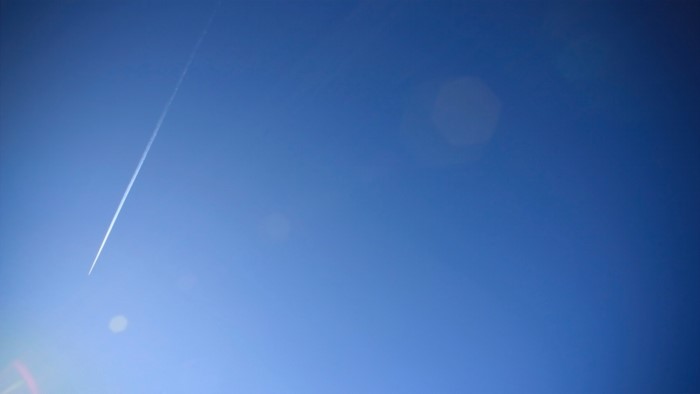 Airplane contrail in a clear blue sky